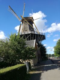 Low angle view of traditional windmill against sky