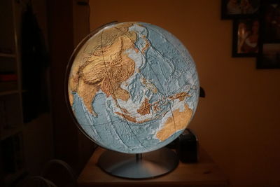 Close-up of illuminated lamp on table