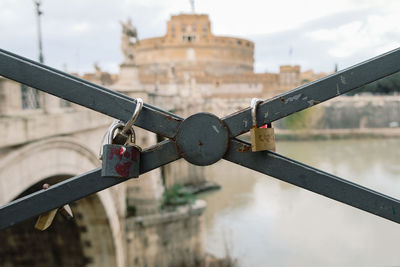 Love locks on sant'angelo castle blurred background in rome, valentine's day
