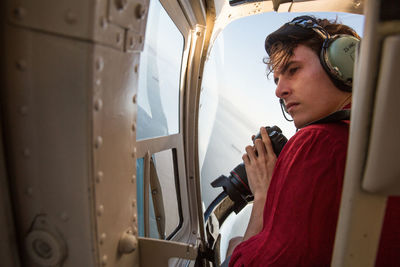 Man photographing in helicopter