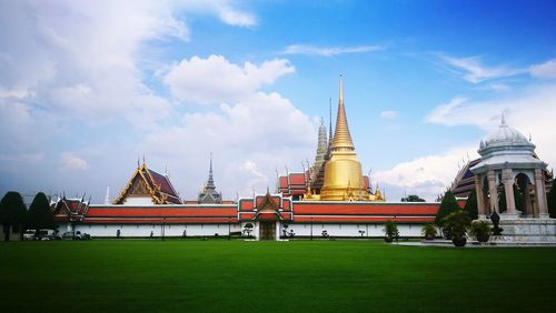 Temple by building against sky