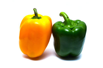 Close-up of yellow bell peppers against white background