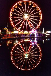 Low angle view of ferris wheel at night