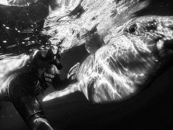 Close-up woman with fish swimming in sea