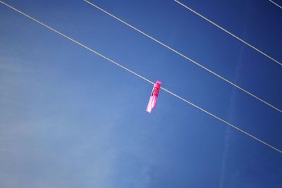 Low angle view of vapor trail against clear blue sky