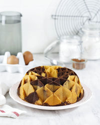 Marble bundt cake, butter cake with vanilla and chocolate batter on wooden table. white bakery 