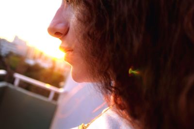 Close-up of teenage girl against sunlight