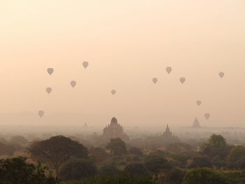Hot air balloons against sky during sunset