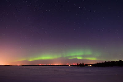 Scenic view of snow against sky at night