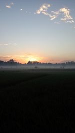 Scenic view of field against sky during sunset