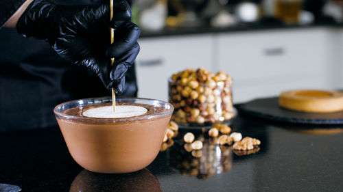 Cropped hand of chef preparing food