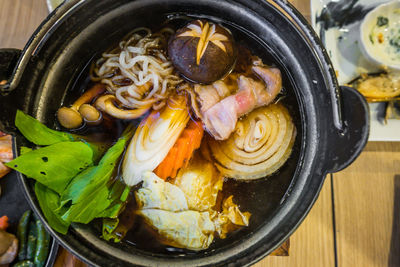 Directly above shot of japanese beef sukiyaki in utensil on table