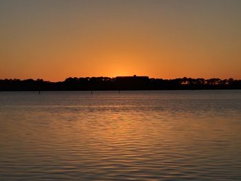 Scenic view of sea against orange sky