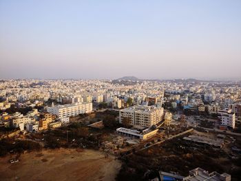 High angle view of city buildings against clear sky