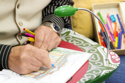 Close-up of hands working on paper