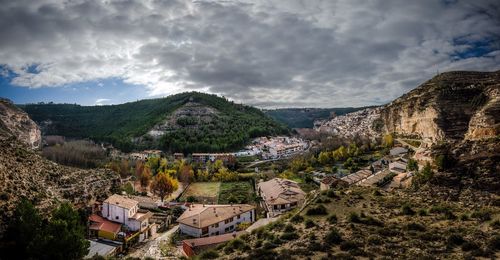 Panoramic view of mountain range against cloudy sky