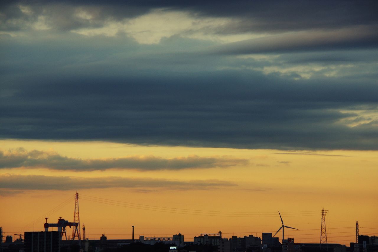 SILHOUETTE OF FACTORY AGAINST SKY