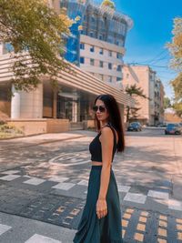 Full length portrait of woman standing in city