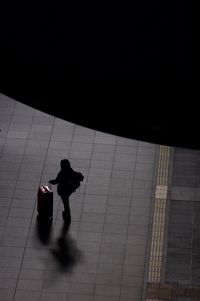 High angle view of people walking on tiled floor