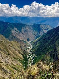 High angle view of land and mountains against sky