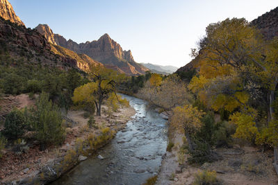 Scenic view of river amidst mountains against sky