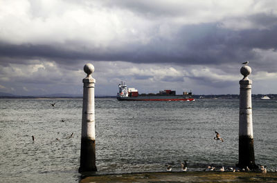 Scenic view of calm sea against cloudy sky