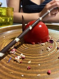 Close-up of hand holding ice cream on table