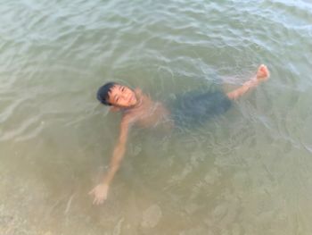 High angle view of woman swimming in sea