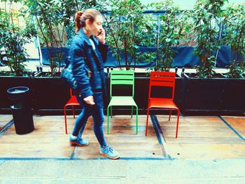 Young woman standing on bench