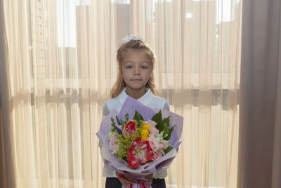 Portrait of girl standing against blue wall