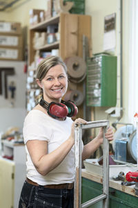 Smiling woman with old window frame