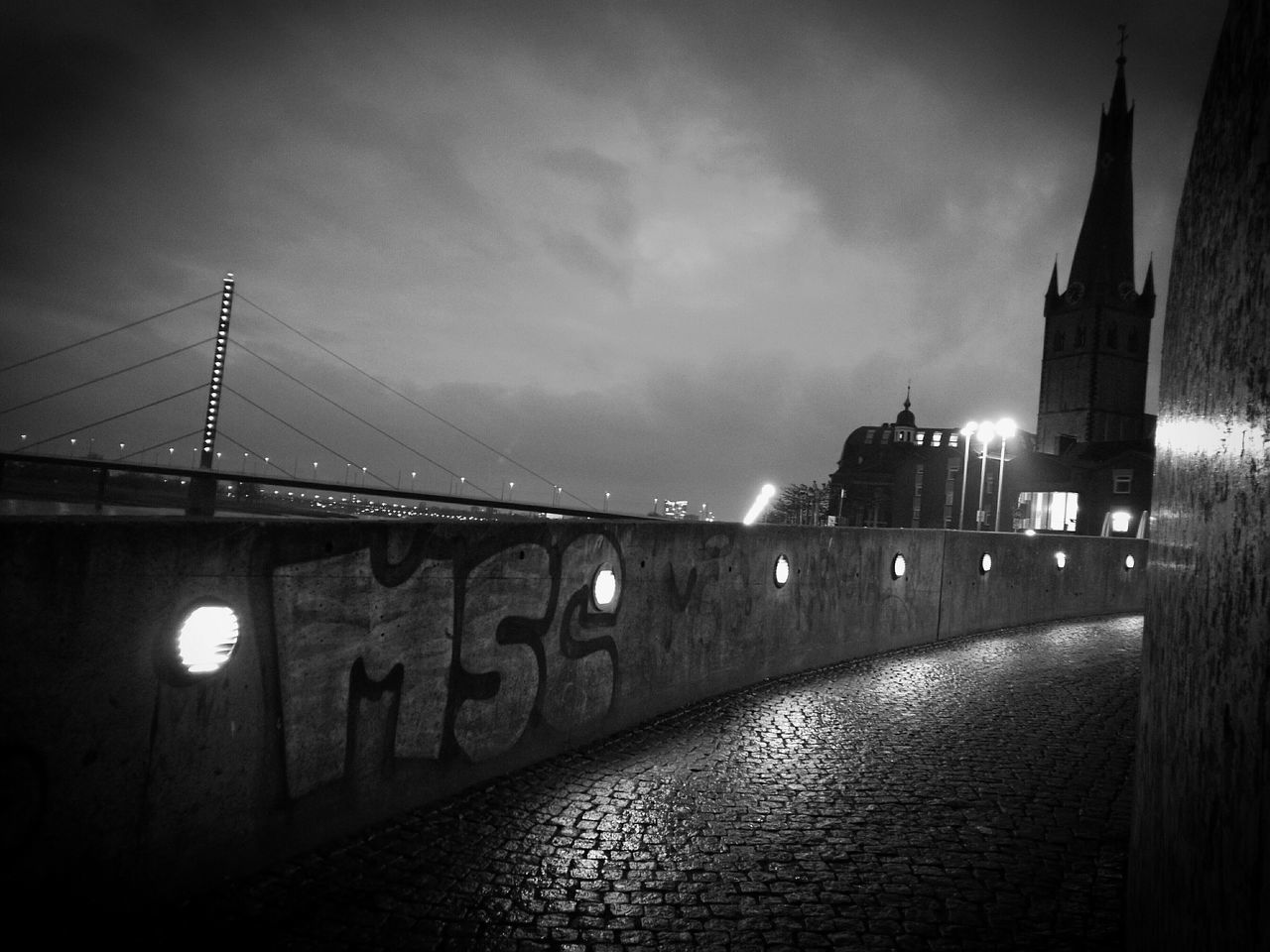 ILLUMINATED BRIDGE IN CITY AT NIGHT