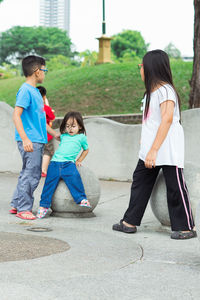 Siblings playing at park