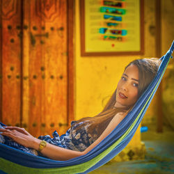 Portrait of beautiful young woman sitting outdoors