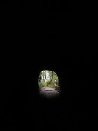 View of tunnel through hole in the dark