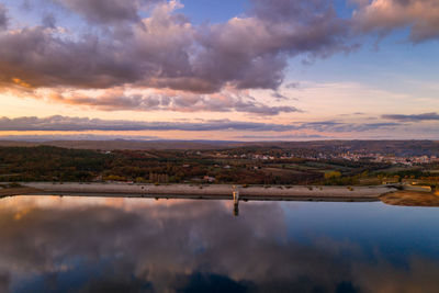 Drone aerial view of a lake reservoir of a dam with reflection on the water in sabugal, portugal