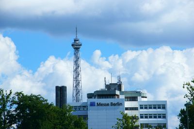 Low angle view of buildings against cloudy sky