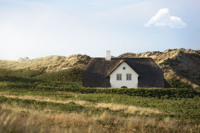 House on field against sky