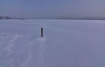 Frozen landscape against sky