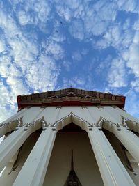 Low angle view of building against cloudy sky