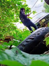 Low angle view of man against trees