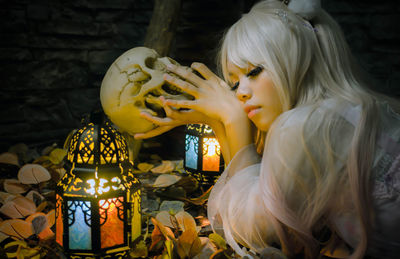 Rear view of girl holding illuminated sculpture