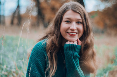 Portrait of smiling girl sitting on field