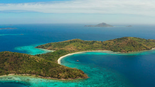 Tropical island with blue lagoon, coral reef and sandy beach. ditaytayan, palawan, philippines. i