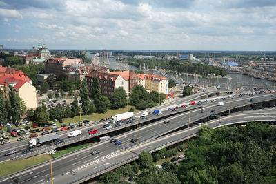 High angle view of vehicles on road in city against sky