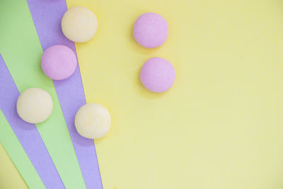 Directly above shot of pills on yellow background