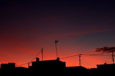 Low angle view of silhouette building against sky during sunset