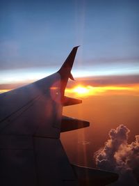 Close-up of airplane wing at sunset