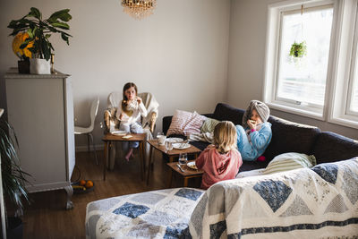 Girls eating on sofa