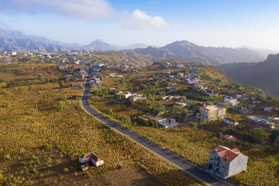 High angle view of buildings on field against sky